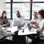 Millennial black businesswoman addressing colleagues at a corporate business meeting, close up